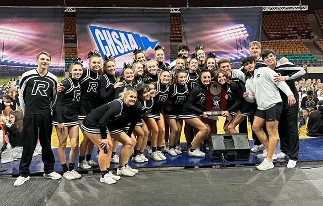 A group of cheerleaders posing for a picture.